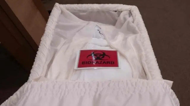 Coffin with 'biohazard' sign