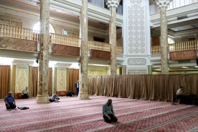 Iranian worshippers pray as they keep social distancing at a mosque in Tehran in Tehran on 30 April 2020