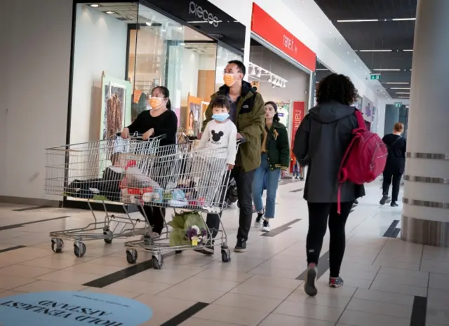 People in a shopping centre wearing face masks in Denmark