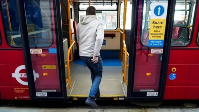 Man getting on London bus