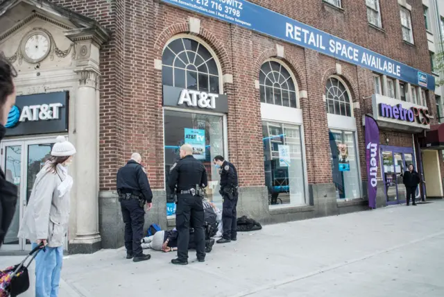 NYPD officers arrest a man on 2 May for spitting at people on the street