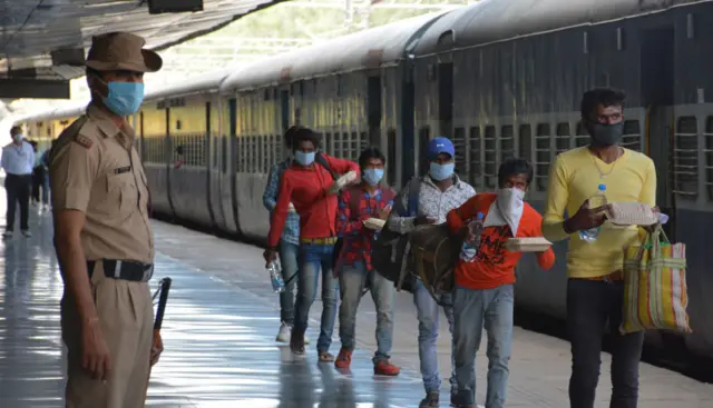 Migrant workers boarding a special train on 11 May