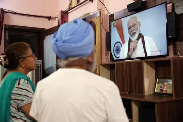 A family in Amritsar watch Indian Prime Minister Narendra Modi's address. Photo: 12 May 2020