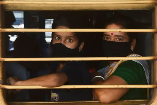 People wearing masks on a train at Kolkata's railway station, India. Photo: 12 May 2020