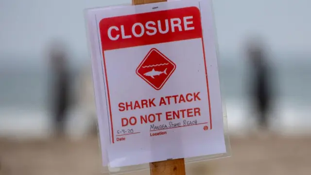 A sign at Sand Dollar Beach says it is closed because of the fatal shark attach on Ben Kelly