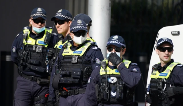 Line of police wearing masks at a protest in Melbourne