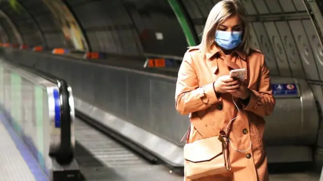 Woman in a London Underground tunnel