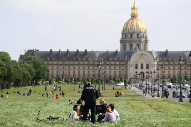 Police officers check people at les Invalides as France is slowly reopening after almost two months of strict lockdown throughout the country due to the epidemic of coronavirus