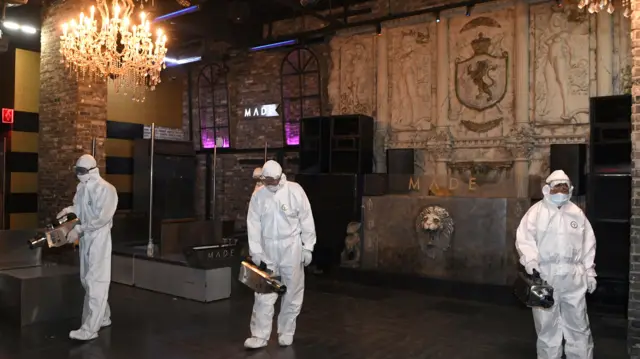 Workers disinfecting a nightclub in Seoul