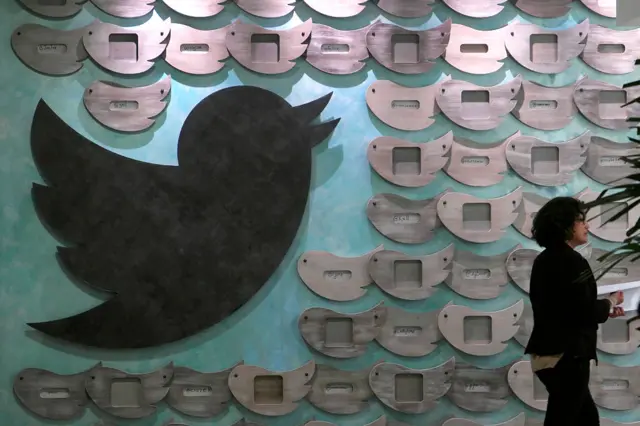 A woman walks past artwork at tech company Twitter's office space in Santa Monica, California