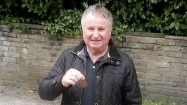 Dale Moxon holding his great uncle's medal