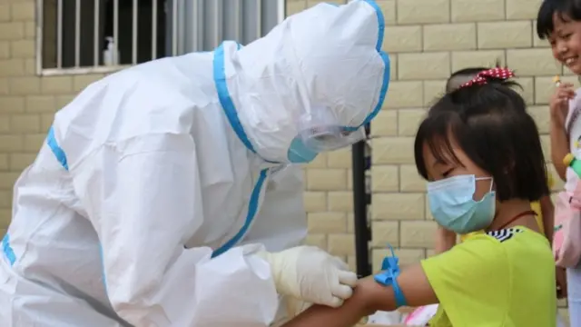 Medic preparing to take blood sample from a child