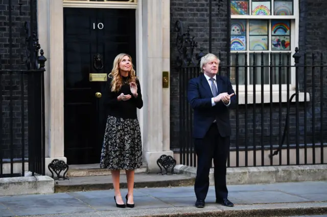 Prime Minister Boris Johnson and his fiance Carrie Symonds clap for carers, NHS staff and other key workers who have been on the frontline of this pandemic