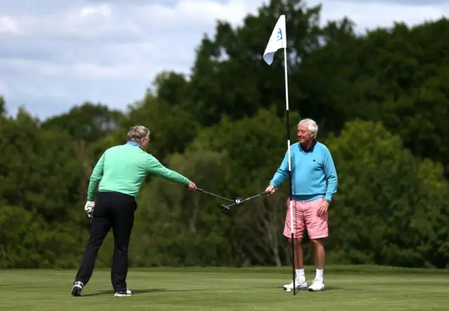 Golfers touching clubs after a game