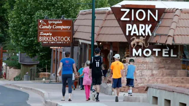 A family walking to Zion National Park in Springdale, Utah