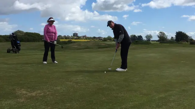 Karen Wright and Steve Mitchell playing golf