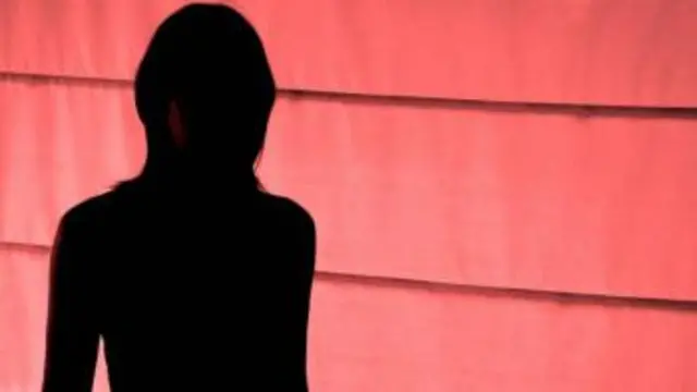 Silhouette of woman over red background