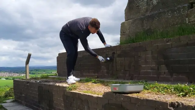 Graffiti being cleaned off