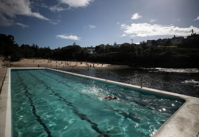 A person swims at an ocean pool at Clovelly in Sydney