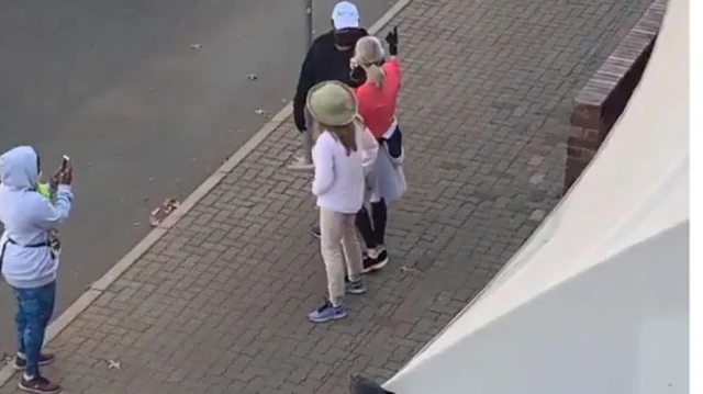 The video shows the three people getting close up