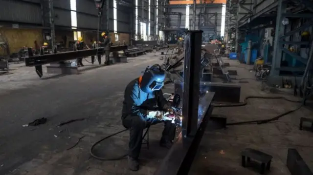 A man working at a factory in India.