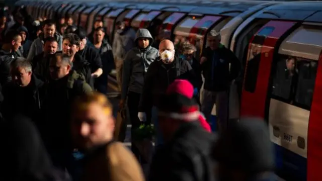 Commuters on a busy platform in London