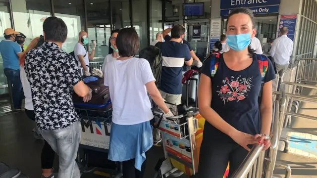 People at airport wearing face masks