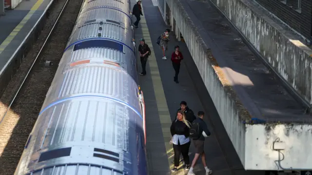 Passengers board and leave a train at a station in Bracknell, Berkshire, as train services increase as part of the easing of coronavirus lockdown restrictions.