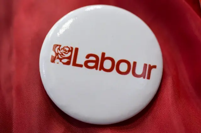 A close-up image of a pin badge bearing the logo for the Labour Party for sale at the Labour Party Conference on September 22, 2014 in Manchester, England.