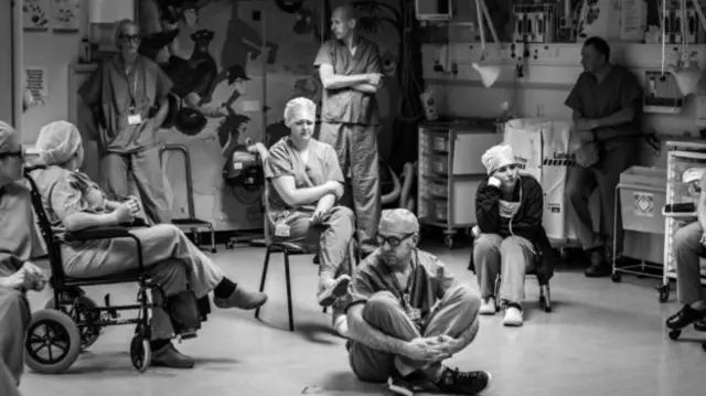 Medics sitting and standing together at Nevill Hall Hospital