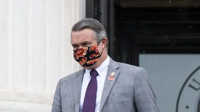 Don Bacon wearing a face mask with bacon on it