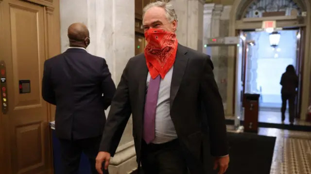 Man wearing a bandana over his nose and mouth