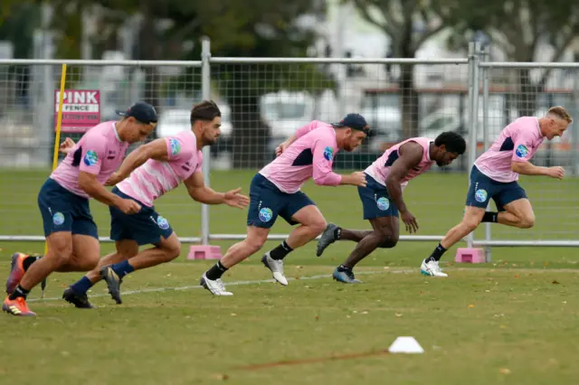 Melbourne Rebels Super Rugby players train behind a temporary fence in order to adhere to COVID-19 protocols at Gosch's Paddock on May 19, 2020 in Melbourne, Australia.