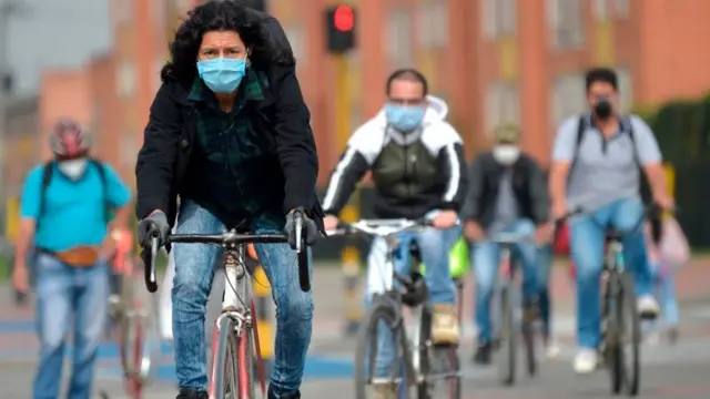 People cycling with face masks on