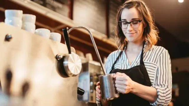 Woman making a coffee