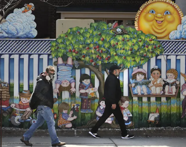 Pedestrians pass a closed childcare centre in Toronto