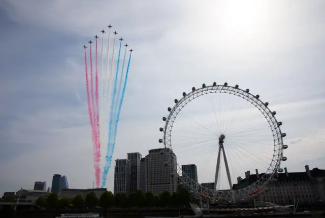 The Royal Air Force Red Arrows pass over the London Eye on the bank of the River Thames during a flypast in central London to mark the 75th anniversary of VE Day.