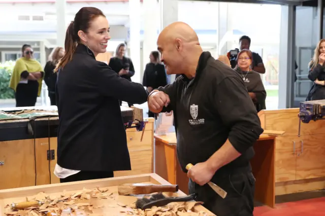 Prime Minister Jacinda Ardern bumps elbows with Albert Te Pou, Master Carver during a tour of Te Puia New Zealand Māori Arts and Crafts Institute on May 19, 2020 in Rotorua, New Zealand.