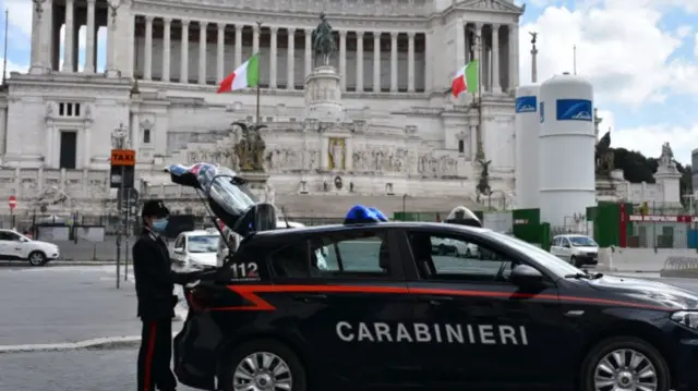 Italian security forces stand guard at a checkpoint at Rome's Piazza Venezia