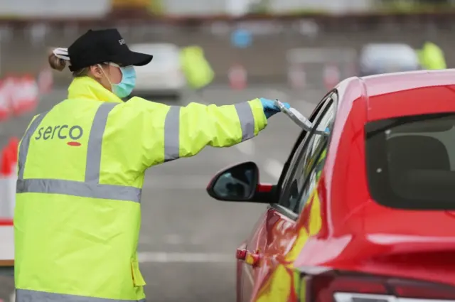 Member of the public at a drive-through test centre at the SSE Arena in Belfast