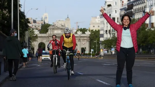 People are seen running and cycling through Puerta de Alcala on the first day since Spain eased the Covid-19 lockdown measures to allow exercise on May 2, 2020 in Madrid , Spain