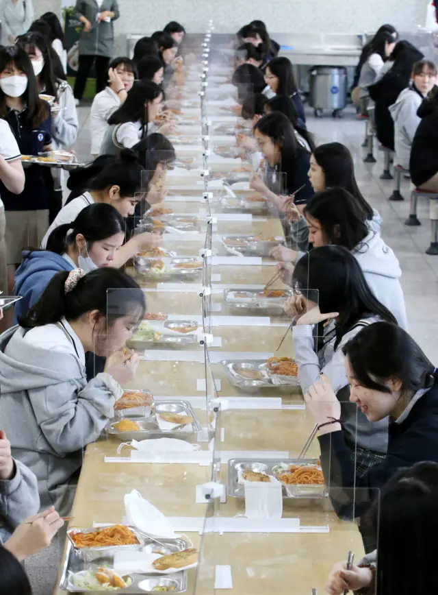 High school seniors having lunch at tables fitted with plastic dividers in the southern city of Daejon, South Korea on May 20.