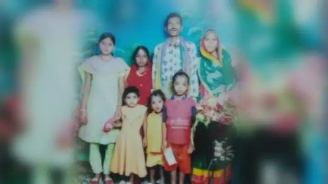 Naresh Singh with his wife (standing to his right) and children