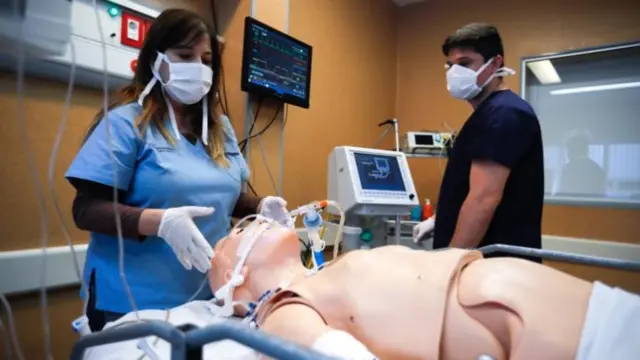 Medical staff with a dummy patient