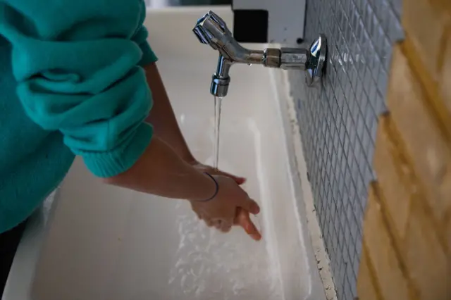 A child washing her hands in a school in Denmark