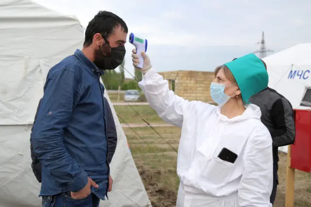 A man has his temperature taken in Dagestan