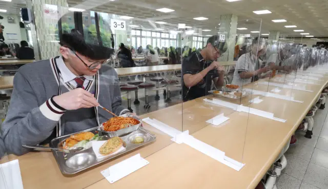 High school seniors having lunch at tables fitted with plastic dividers in the southern city of Daejon, South Korea on May 20.