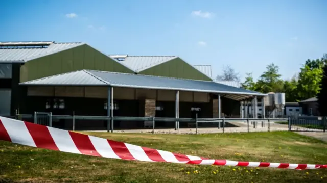 This general view shows barrier tape cordoning off buildings of a mink farm at Beek en Donk