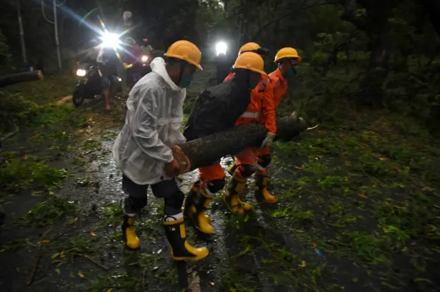 Members of National Disaster Rescue Force (NDRF) remove a branch of an uprooted tree after Cyclone Amphan made its landfall, in Digha, near the border between the eastern states of West Bengal and Odisha, India, May 20, 2020