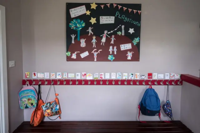 A cloakroom with a few bags on pegs is seen at Marsden Infant and Nursery School in Marsden, near Huddersfield, northern England on May 18, 2020